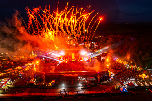 Herzogenaurach Germany 24 July 2025 Aerial view of the Open Beatz Festival with vibrant fireworks exploding over a large crowd and illuminated stages at night.