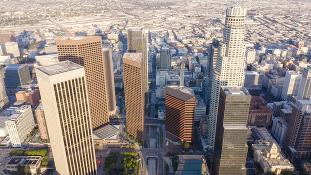 Aerial view of the Los Angeles skyline featuring modern skyscrapers dense urban architecture and city streets in Los Angeles California United States.