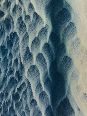 Aerial view of glacial rivers weaving through volcanic sands creating a mesmerizing tapestry of dark and light contrasting patterns Iceland Iceland. Aerial view of glacial rivers weaving through volcanic sands creating a mesmerizing tapestry of dark and light contrasting patterns Iceland Iceland.