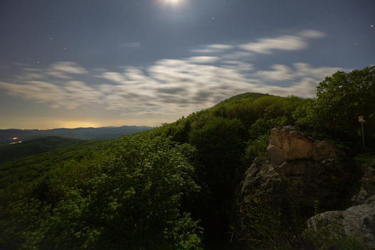 View of Havrania skala rock formation under a starry night sky with moonlit clouds over the Male Karpaty mountains Smolenice Trnava Region Slovakia. View of Havrania skala rock formation under a starry night sky with moonlit clouds over the Male Karpaty mountains Smolenice Trnava Region Slovakia.