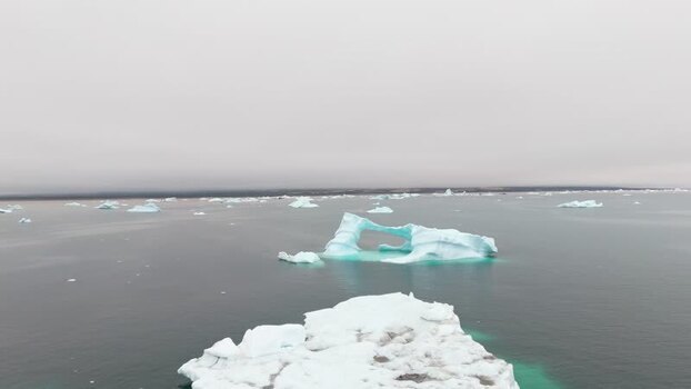 Aerial view of icebergs floating near Disko Island Greenland. Aerial view of icebergs floating near Disko Island Greenland.