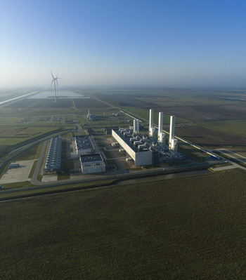 Aerial view of the nitrogen plant industrial facility with white stacks and surrounding green fields under a clear blue sky in Zuidbroek Groningen Netherlands. Aerial view of the nitrogen plant industrial facility with white stacks and surrounding green fields under a clear blue sky in Zuidbroek Groningen Netherlands.