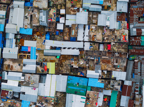 Dhaka Bangladesh 19 June 2026 Aerial view of dense urban housing with colorful corrugated metal roofs and narrow alleyways in the city of Dhaka.