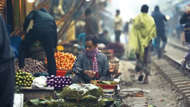 View of people selling vegetables at a railway market Bangladesh. View of people selling vegetables at a railway market Bangladesh.