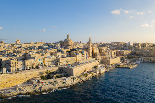 Aerial view of the historic skyline of Valletta featuring the Basilica of Our Lady of Mount Carmel and St. Paul s Pro Cathedral overlooking the Mediterranean Sea in Valletta Port Region Malta. Aerial view of the historic skyline of Valletta featuring the Basilica of Our Lady of Mount Carmel and St. Paul s Pro Cathedral overlooking the Mediterranean Sea in Valletta Port Region Malta.