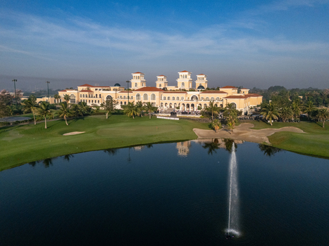 Ahmedabad Gujarat India 21 March 2026 Aerial view of Kalhaar Blues Greens Golf Club with its large clubhouse manicured fairways and a pond with a fountain.