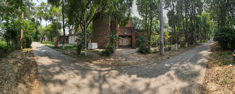 Lahore Pakistan 08 September 2026 Aerial view of the Fisheries Complex in Manawan featuring brick architecture surrounded by lush trees and pathways.