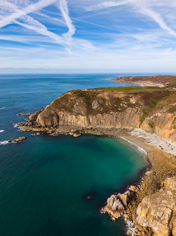 Aerial view of the rugged cliffs of Nez de Jobourg overlooking the turquoise waters of the English Channel in La Hague Normandie France. Aerial view of the rugged cliffs of Nez de Jobourg overlooking the turquoise waters of the English Channel in La Hague Normandie France.