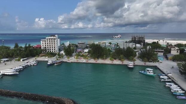 Aerial view of the harbor and coastal buildings in Maldives. Aerial view of the harbor and coastal buildings in Maldives.