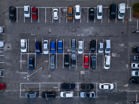 Aerial view of a parking lot filled with various cars parked in marked spaces in Gdansk Poland. Aerial view of a parking lot filled with various cars parked in marked spaces in Gdansk Poland.