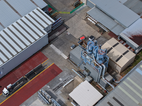 Melbourne VIC Australia 25 September 2026 Aerial view of an industrial factory complex featuring metal structures machinery and a truck parked in the paved yard.