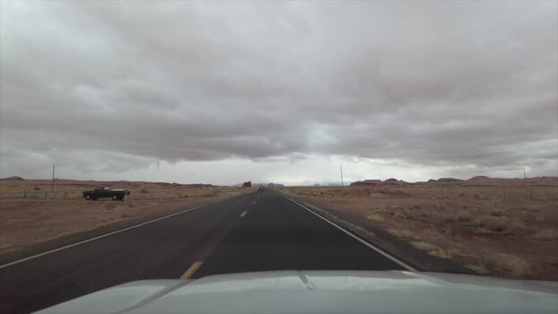 View of a desert highway and distant mesas United States. View of a desert highway and distant mesas United States.