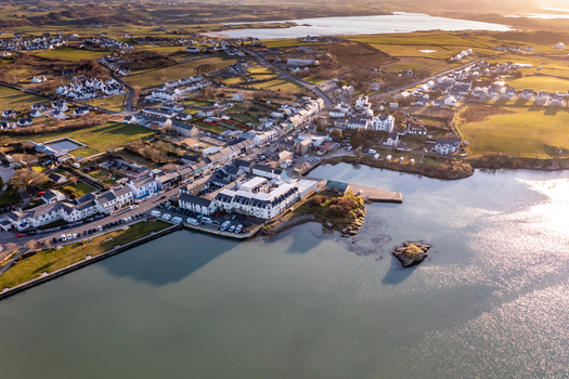 Aerial view of the coastal village of Dunfanaghy with its harbor traditional buildings and surrounding green fields in Dunfanaghy County Donegal Ireland. Aerial view of the coastal village of Dunfanaghy with its harbor traditional buildings and surrounding green fields in Dunfanaghy County Donegal Ireland.