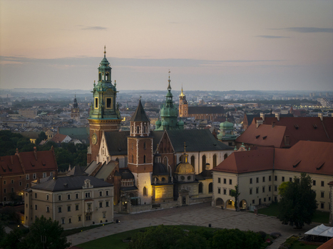 Aerial view of Wawel Royal Castle with its historic towers domes and red tiled roofs set against the urban skyline of Krakow Lesser Poland Voivode Poland. Aerial view of Wawel Royal Castle with its historic towers domes and red tiled roofs set against the urban skyline of Krakow Lesser Poland Voivode Poland.