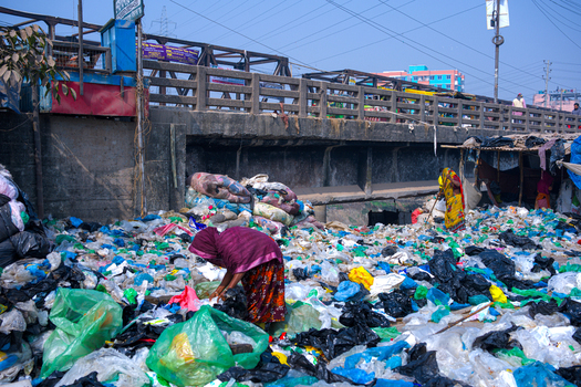 Keraniganj Bangladesh 06 January 2026 View of women collecting recyclable materials from a massive pile of plastic waste under a bridge. Keraniganj Bangladesh 06 January 2026 View of women collecting recyclable materials from a massive pile of plastic waste under a bridge.