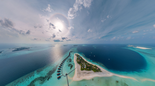 Aerial view of island resorts with overwater bungalows and pristine turquoise waters under a bright sun Malé Malé Maldives. Aerial view of island resorts with overwater bungalows and pristine turquoise waters under a bright sun Malé Malé Maldives.