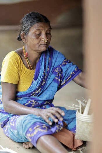 Odisha India 26 March 2026 View of a woman adorned in a vibrant blue saree and yellow blouse sits crafting with delicate precision light filtering through the scene. Odisha India 26 March 2026 View of a woman adorned in a vibrant blue saree and yellow blouse sits crafting with delicate precision light filtering through the scene.