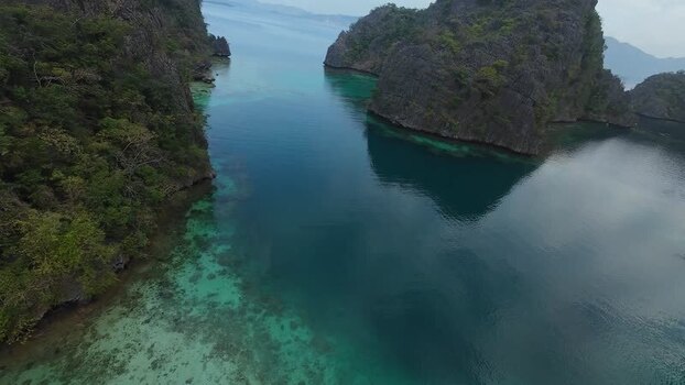FPV aerial view of Kayangan Lake and limestone cliffs Philippines. FPV aerial view of Kayangan Lake and limestone cliffs Philippines.