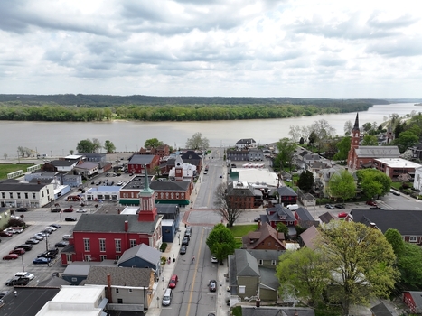 Aerial view of small town streets historic brick buildings and a church steeple overlooking the Ohio River under a cloudy sky Aurora Indiana United States. Aerial view of small town streets historic brick buildings and a church steeple overlooking the Ohio River under a cloudy sky Aurora Indiana United States.