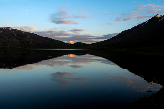 View of Sheosar Lake with calm water reflecting the surrounding mountains and sunset clouds in Skardu Pakistan. View of Sheosar Lake with calm water reflecting the surrounding mountains and sunset clouds in Skardu Pakistan.
