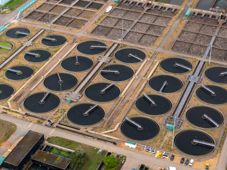 Aerial view of the water treatment plant with circular sedimentation tanks and infrastructure in Broughton England United Kingdom. Aerial view of the water treatment plant with circular sedimentation tanks and infrastructure in Broughton England United Kingdom.