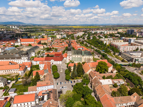 Aerial view of Saint Nicolas Basilica and the historic old town with red rooftops and green trees under a cloudy sky in Trnava Trnava Region Slovakia. Aerial view of Saint Nicolas Basilica and the historic old town with red rooftops and green trees under a cloudy sky in Trnava Trnava Region Slovakia.