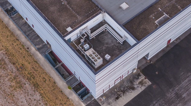 Aerial view of rooftop mechanical ventilation system with industrial air ducts HVAC units and cooling infrastructure on a modern commercial facility in Valence Auvergne Rhone Alpes France.