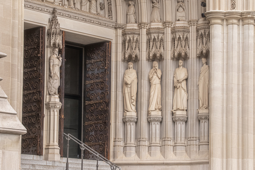 Washington United States 06 May 2025 View of the intricate stone carvings and statues at the entrance of the Washington National Cathedral.
