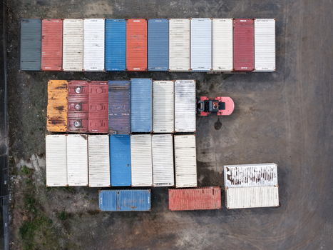 Melbourne Australia 25 September 2026 Aerial view of colorful shipping containers arranged in a storage yard with a forklift operating nearby.