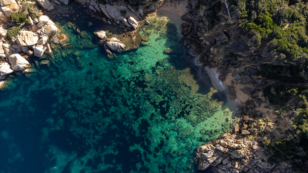 Aerial view of the turquoise waters and granite rock formations of Capo Testa in Santa Teresa Gallura Sardinia Italy. Aerial view of the turquoise waters and granite rock formations of Capo Testa in Santa Teresa Gallura Sardinia Italy.
