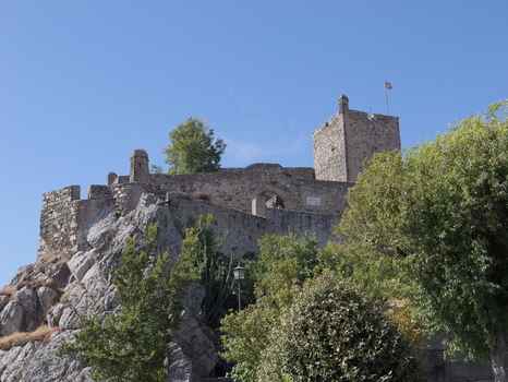 View of the historic stone walls and tower of Marvao Castle perched on a rocky outcrop under a clear blue sky in Marvao Portalegre District Portugal. View of the historic stone walls and tower of Marvao Castle perched on a rocky outcrop under a clear blue sky in Marvao Portalegre District Portugal.
