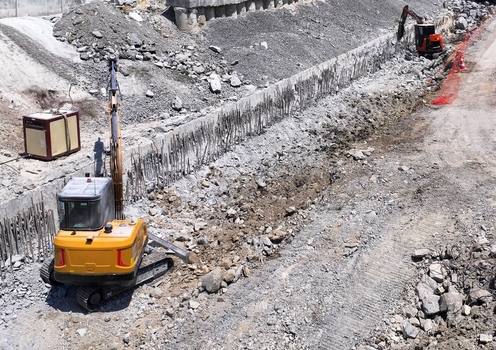 Aerial view of excavators digging earth and moving rubble at a construction site with concrete retaining walls in Istanbul Istanbul Turkiye.
