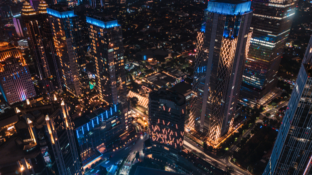Aerial view of illuminated skyscrapers and modern architecture in the central business district of Jakarta Indonesia.