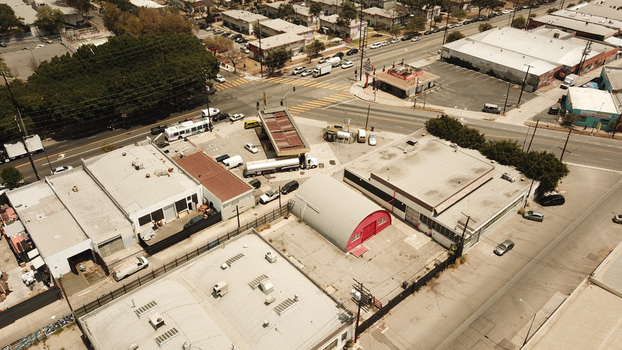 Aerial view of a gas station and industrial buildings in an urban neighborhood in Los Angeles California United States. Aerial view of a gas station and industrial buildings in an urban neighborhood in Los Angeles California United States.