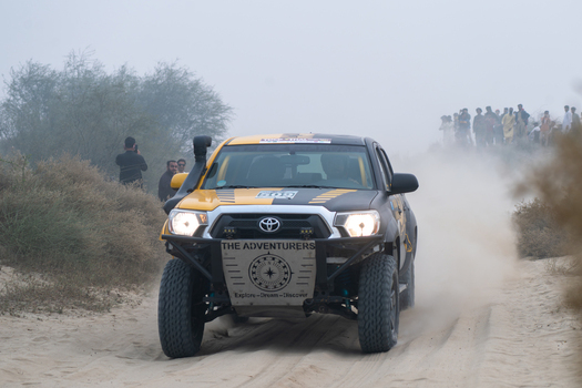 Kot Addu Punjab Pakistan 08 November 2024 View of Changa Manga Tila Thal Jeep Rally Point with a modified off road vehicle racing through the sandy desert terrain.
