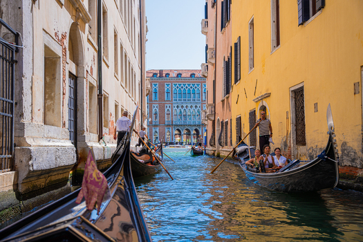 Venice Italy 29 March 2026 View of gondolas glide along a narrow canal framed by the warm hues of aged buildings reflecting the bright sky in the tranquil water. Venice Italy 29 March 2026 View of gondolas glide along a narrow canal framed by the warm hues of aged buildings reflecting the bright sky in the tranquil water.
