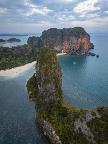 Aerial view of towering limestone cliffs meet the turquoise waters fringed by pristine beaches Railay Beach Krabi Thailand. Aerial view of towering limestone cliffs meet the turquoise waters fringed by pristine beaches Railay Beach Krabi Thailand.