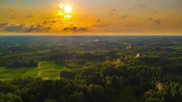 Aerial view of sunset over the forests and fields of Latvia. Aerial view of sunset over the forests and fields of Latvia.