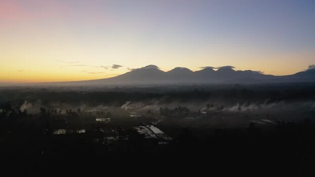 Aerial view of volcanic mountains at dawn with mist in the valley Indonesia. Aerial view of volcanic mountains at dawn with mist in the valley Indonesia.