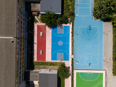 Aerial view of the colorful sports courts at the Fourth Foreign Language School Frederic Joliot Curie featuring basketball surfaces and school buildings in Varna Varna Bulgaria. Aerial view of the colorful sports courts at the Fourth Foreign Language School Frederic Joliot Curie featuring basketball surfaces and school buildings in Varna Varna Bulgaria.