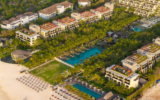 Aerial view of The Apurva Kempinski Bali featuring luxury resort architecture lush gardens swimming pools and a sandy beach in Kecamatan Kuta Selatan Bali Indonesia. Aerial view of The Apurva Kempinski Bali featuring luxury resort architecture lush gardens swimming pools and a sandy beach in Kecamatan Kuta Selatan Bali Indonesia.