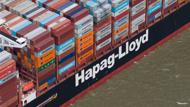 Corringham United Kingdom 10 July 2026 Aerial view of a Hapag Lloyd container ship at London Gateway showing stacks of colorful shipping containers and the vessel hull.