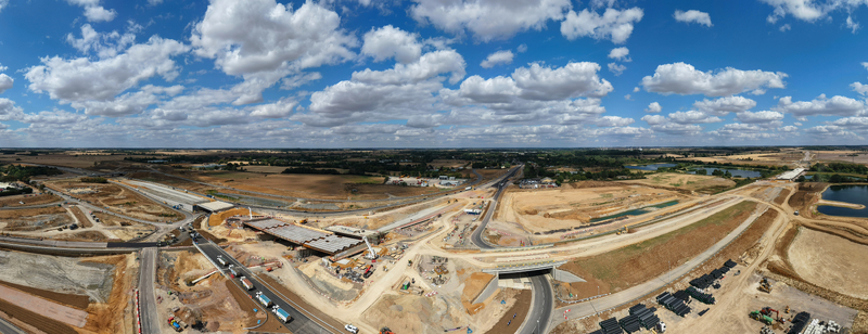 Aerial view of Black Cat Roundabout highway construction showing civil engineering works new road infrastructure heavy machinery and rural landscape in Chawston England United Kingdom. Aerial view of Black Cat Roundabout highway construction showing civil engineering works new road infrastructure heavy machinery and rural landscape in Chawston England United Kingdom.