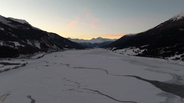 Aerial view of frozen Reschensee lake at sunset Italy. Aerial view of frozen Reschensee lake at sunset Italy.