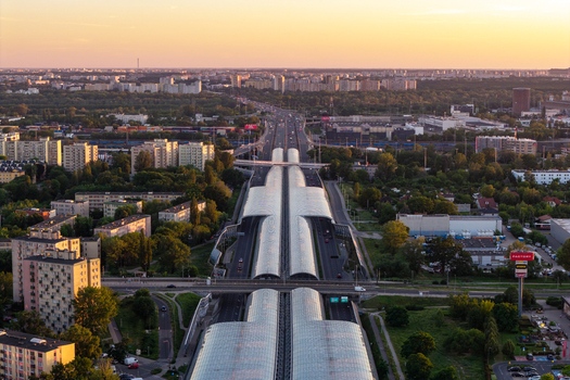 Warszawa Poland 24 June 2026 Aerial view of the Trasa Torunska expressway featuring covered sections surrounded by urban infrastructure and green spaces during golden hour. Warszawa Poland 24 June 2026 Aerial view of the Trasa Torunska expressway featuring covered sections surrounded by urban infrastructure and green spaces during golden hour.
