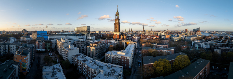 Aerial view of St. Michaeliskirche surrounded by urban buildings and rooftops under a clear sky in Hamburg Hamburg Germany.