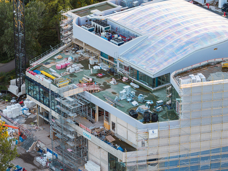 Aerial view of the Ocean Berlin Hotel and Aquarium under construction featuring scaffolding building materials and a large curved roof structure in Berlin Berlin Germany. Aerial view of the Ocean Berlin Hotel and Aquarium under construction featuring scaffolding building materials and a large curved roof structure in Berlin Berlin Germany.