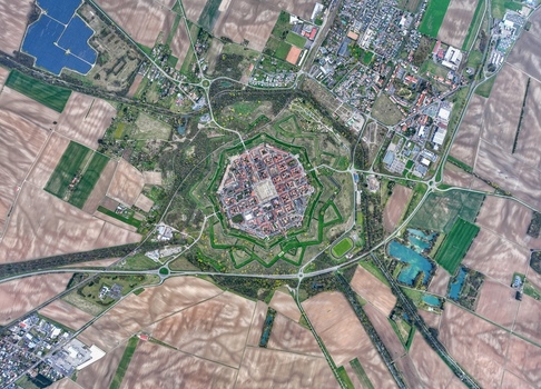 Aerial view of the star shaped fortress city with its intricate bastions and geometric streets amidst the patchwork fields Neuf Brisach Grand Est France.