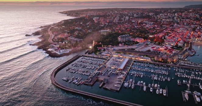 Aerial view of the marina filled with boats coastal architecture and rocky shoreline at sunset in Lisbon Lisbon Portugal. Aerial view of the marina filled with boats coastal architecture and rocky shoreline at sunset in Lisbon Lisbon Portugal.