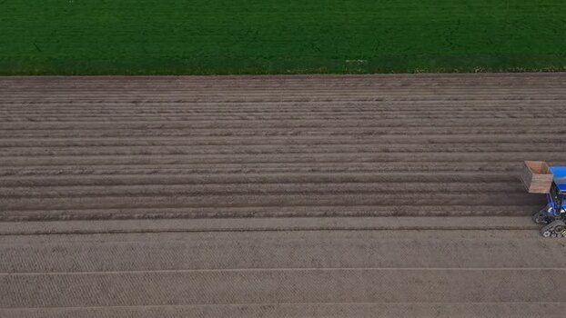 Aerial view of a tractor working in a farm field Netherlands.